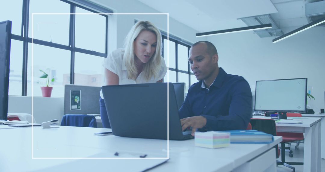 Professional Colleagues Collaborating in Modern Open-Plan Office
