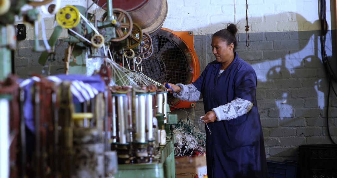 Woman Operating Industrial Yarn Machine in Textile Factory - Free Images, Stock Photos and Pictures on Pikwizard.com