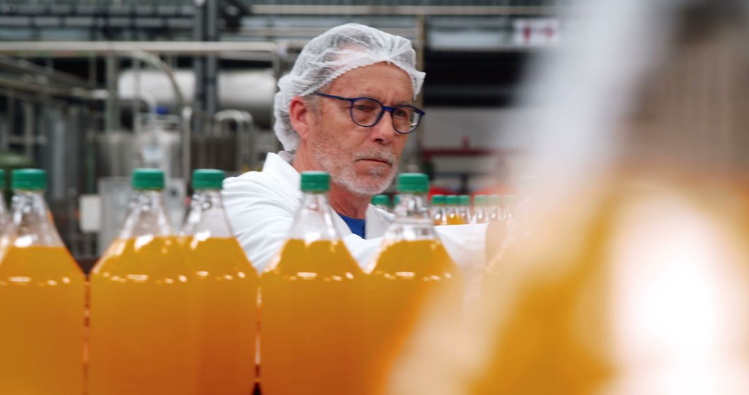 Quality Control Worker Inspecting Bottles in Beverage Factory - Free Images, Stock Photos and Pictures on Pikwizard.com