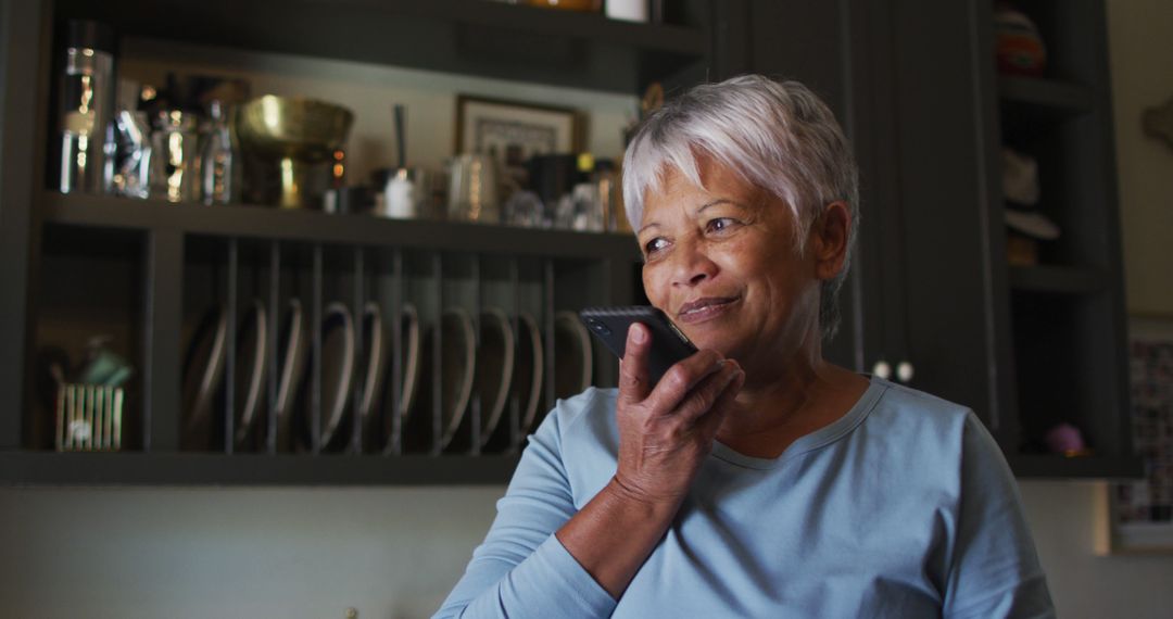 Senior Woman Smiling While Using Voice Command on Smartphone - Free Images, Stock Photos and Pictures on Pikwizard.com