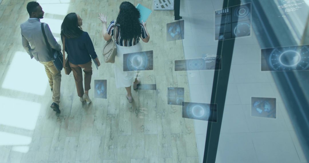 Business team walking through modern lobby with floating digital interface panels