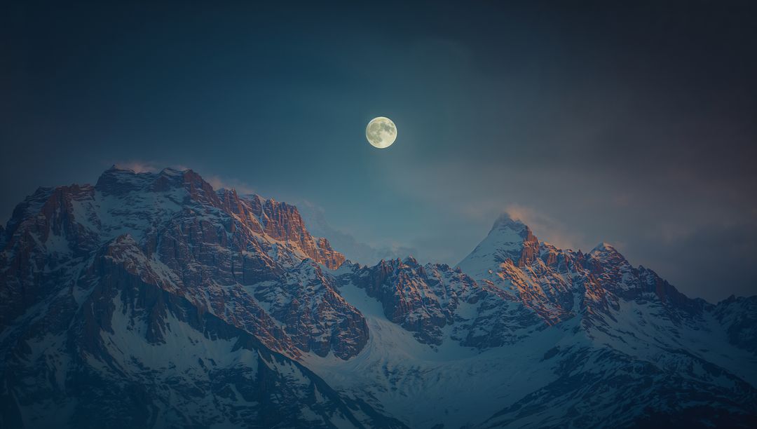 Full Moonlit Dusk Over Snow-Capped Mountain Peaks
