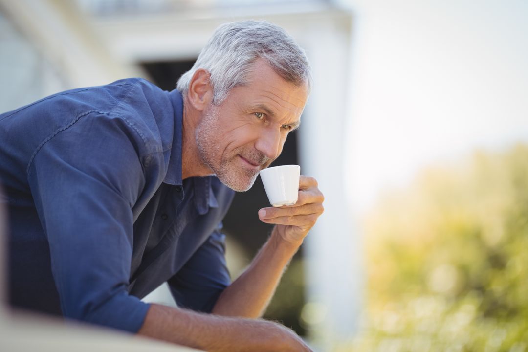 Mature man having coffee in balcony - Free Images, Stock Photos and Pictures on Pikwizard.com