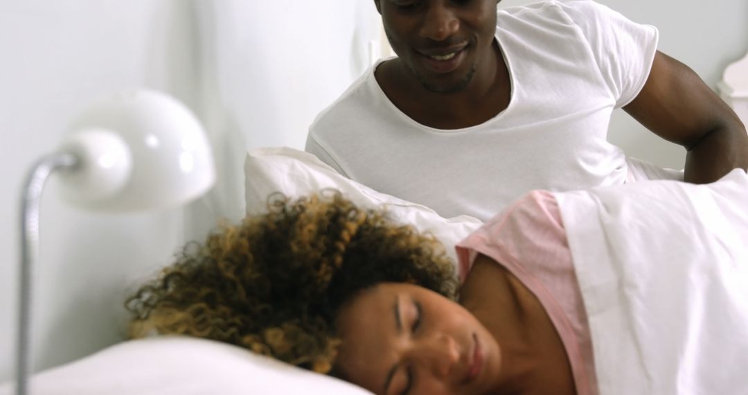 African American Couple Relaxing in Bed with Man Watching Woman Sleep - Free Images, Stock Photos and Pictures on Pikwizard.com