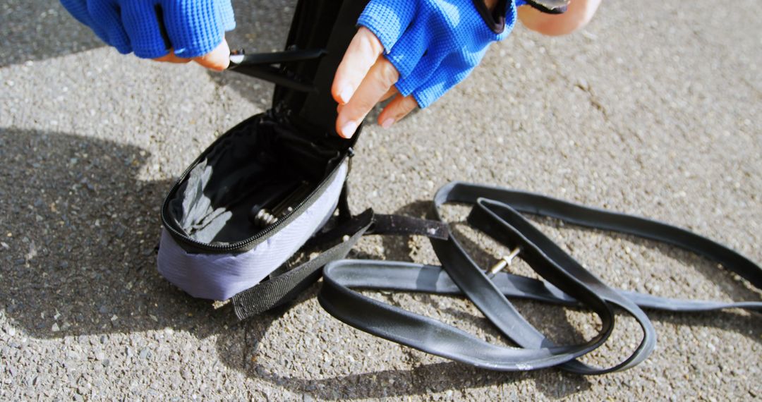 Cyclist Repairing Bike Tire on Sidewalk - Free Images, Stock Photos and Pictures on Pikwizard.com