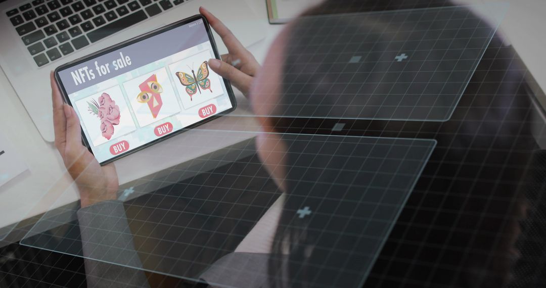 Browsing Digital Art NFTs on Tablet with Laptop in Modern Workspace