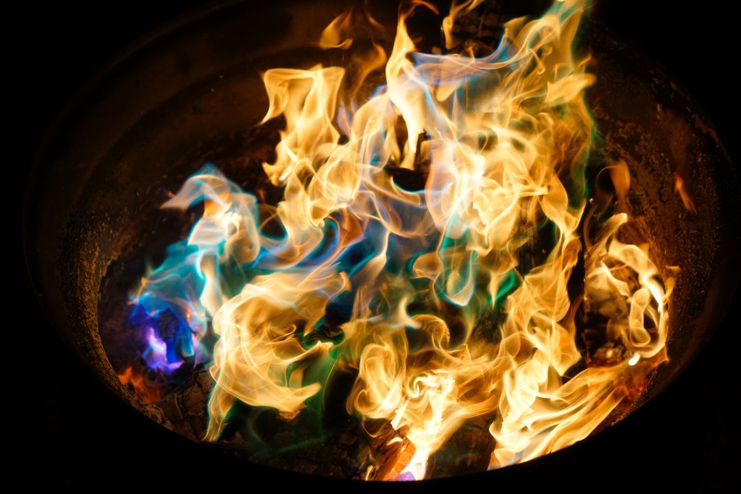 Vibrant Multicolored Flames in Fire Pit Creating Abstract Nighttime Light