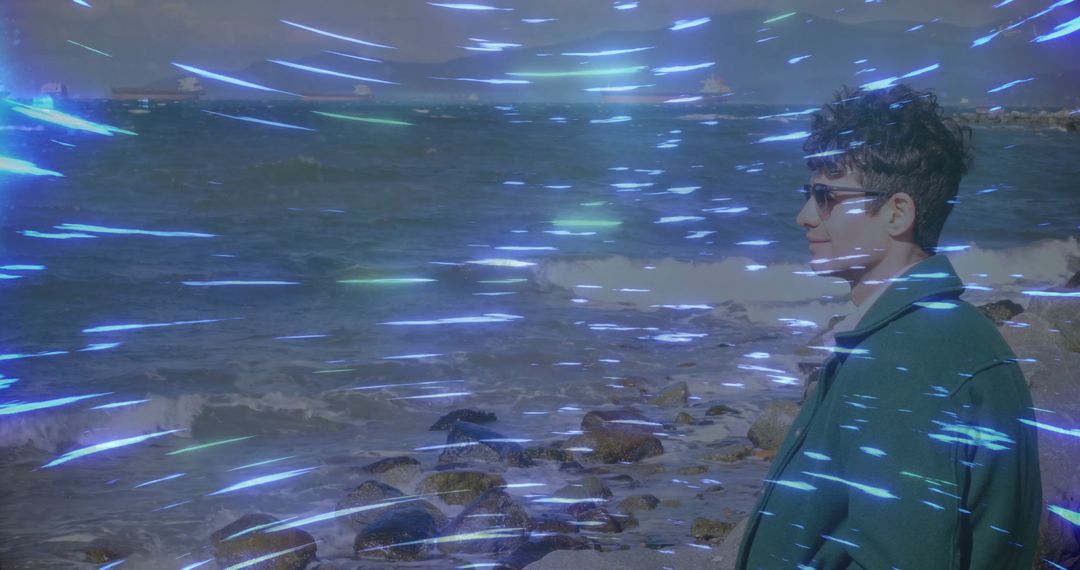 Contemplative Man by Ocean with Surreal Light Streaks