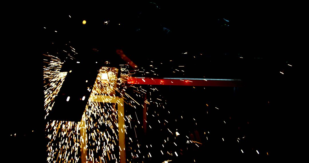 Welder Creating Sparks in Dimly Lit Workshop - Free Images, Stock Photos and Pictures on Pikwizard.com