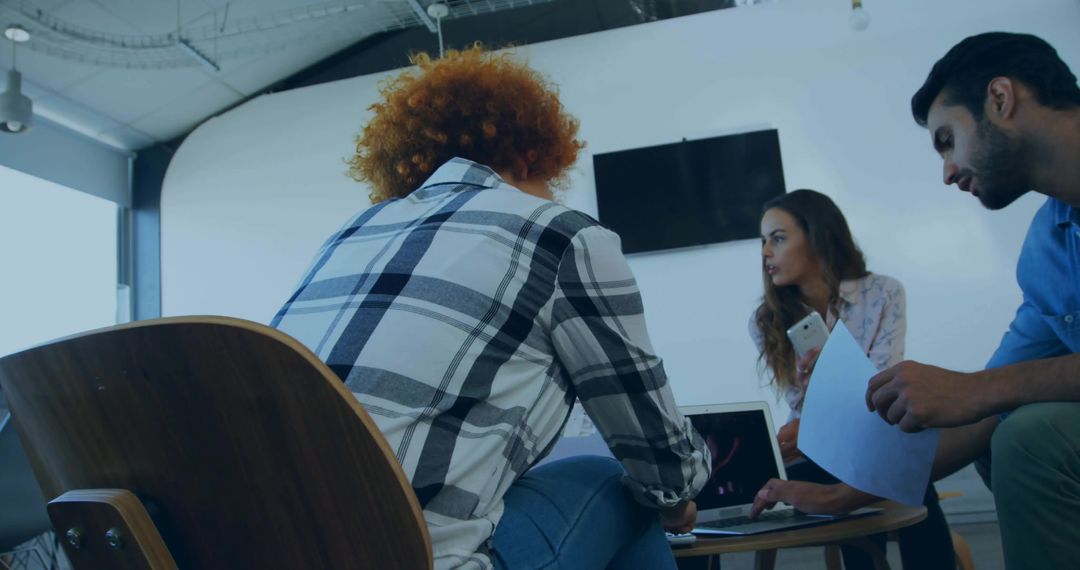 Collaborating Team in Modern Office Discussing Project Details