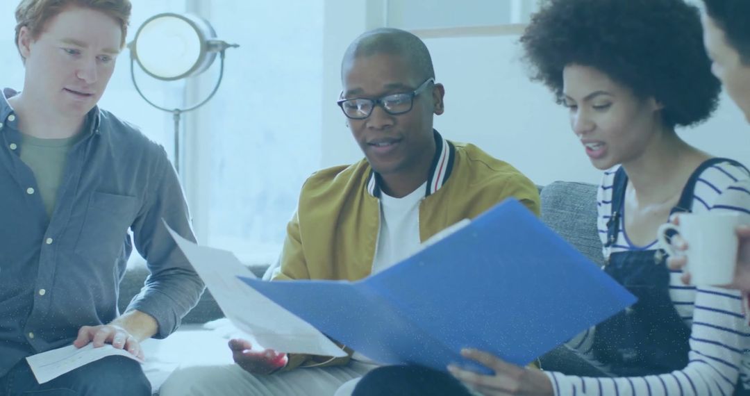 Diverse Team Collaborating Over Financial Documents in Office