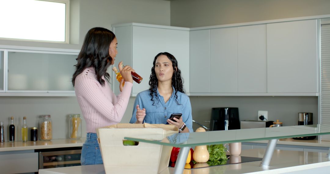 Female Friends Discussing Recipe in Modern Kitchen