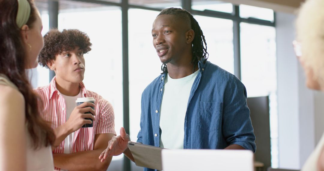 Diverse Team Collaborating in Office with Tablet
