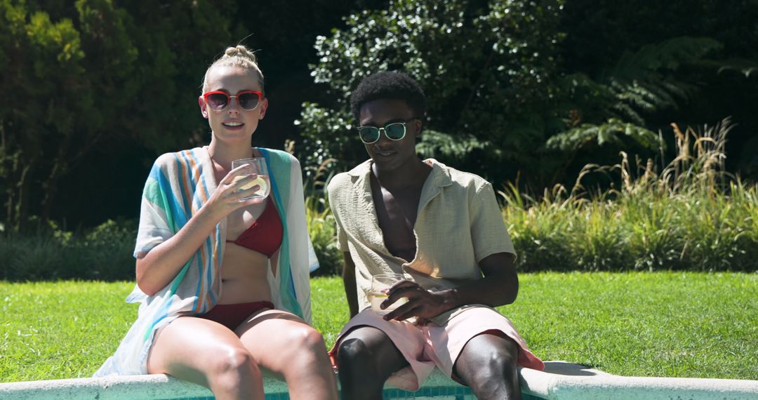 Diverse Friends Relaxing Poolside with Refreshing Drinks