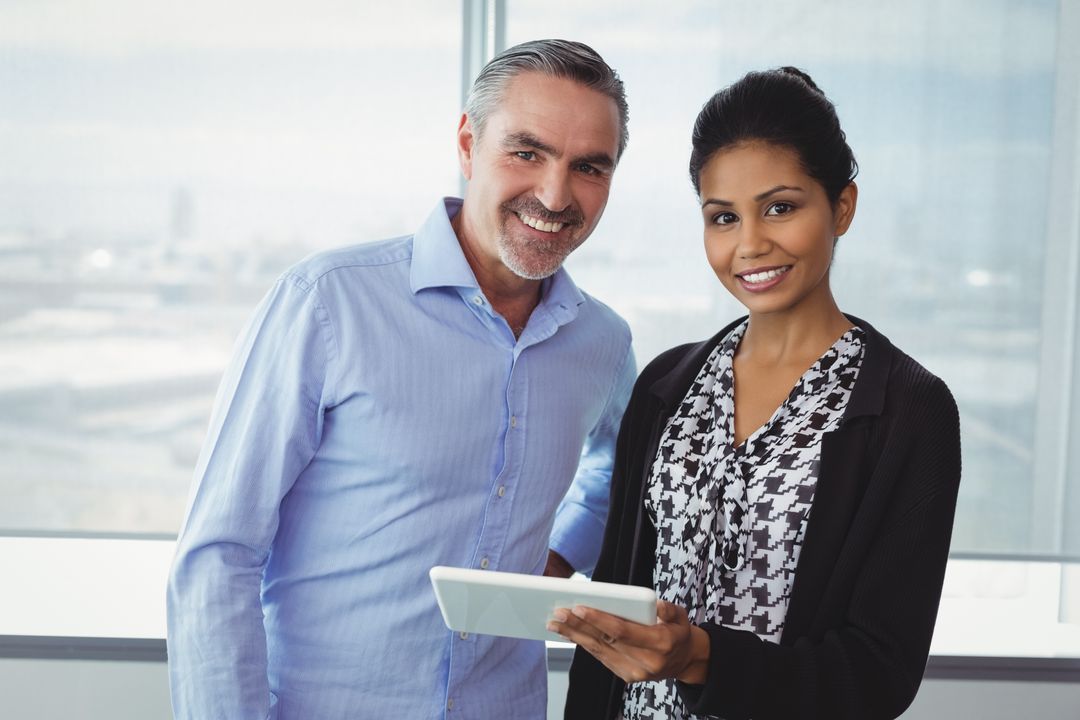 Confident Business Executives Collaborating with Tablet