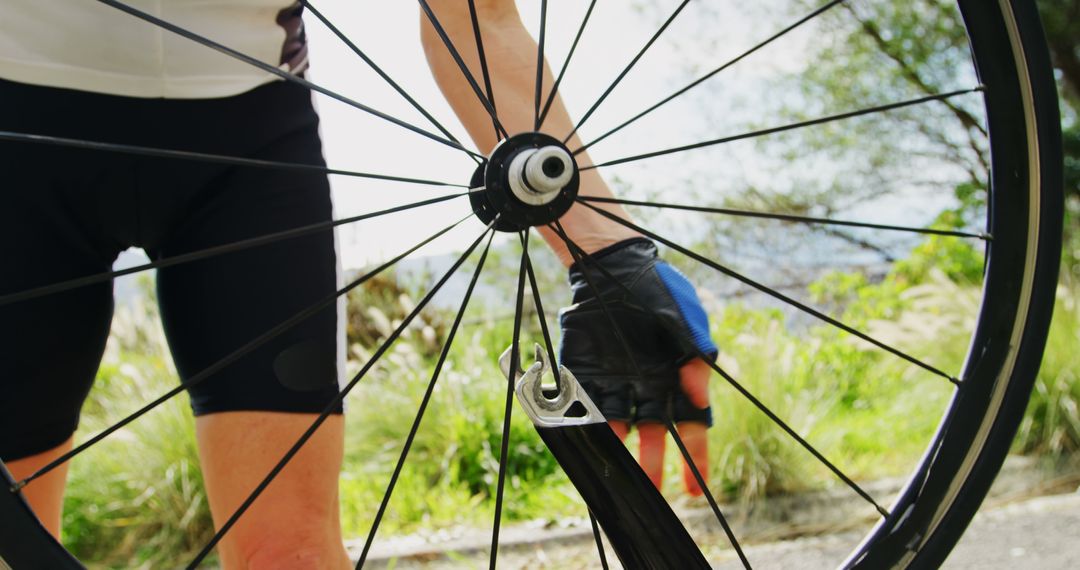 Cyclist Fixing Bicycle Tire Outdoors - Free Images, Stock Photos and Pictures on Pikwizard.com