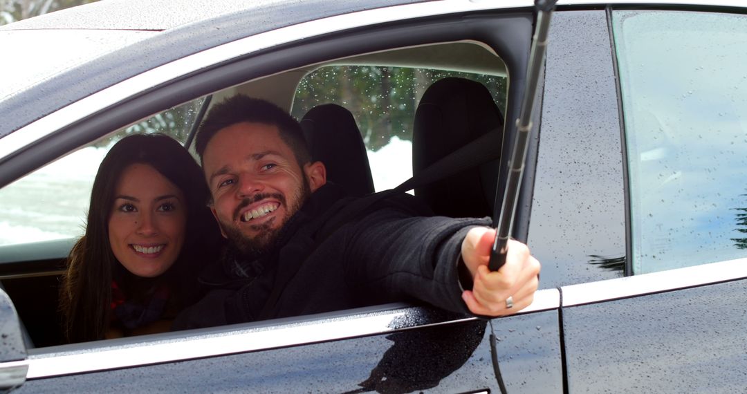 Couple Taking Selfie During Winter Drive in Snowy Landscape - Free Images, Stock Photos and Pictures on Pikwizard.com