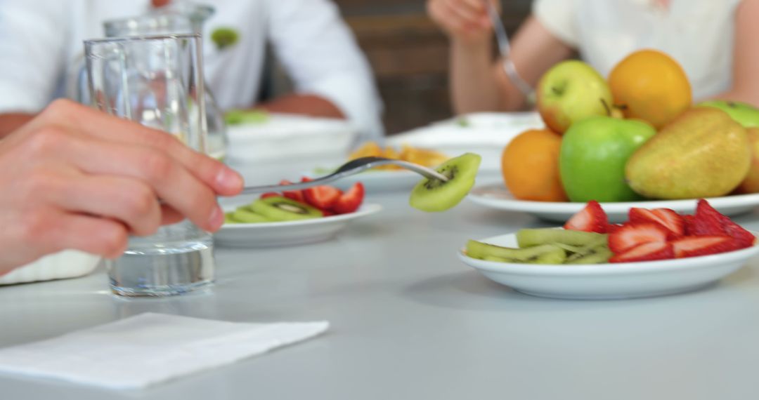 Close-Up of People Enjoying Healthy Fruit Platter Together - Free Images, Stock Photos and Pictures on Pikwizard.com