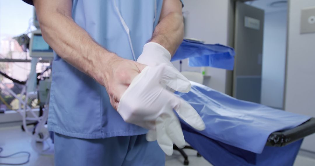 Doctor Putting on Gloves in Sterile Hospital Room - Free Images, Stock Photos and Pictures on Pikwizard.com