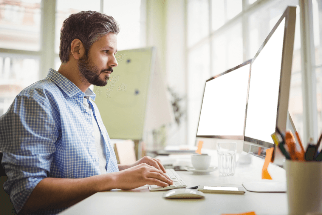 Man Using Desktop Computer in Bright Office Space with Transparent Screens - Download Free Stock Images Pikwizard.com