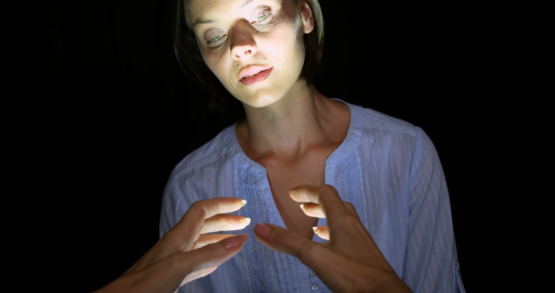 Mysterious Woman Illuminated by Hands with Light - Free Images, Stock Photos and Pictures on Pikwizard.com