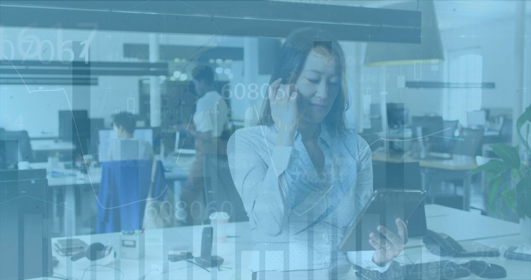 Diverse Business Team Using Tablet with Financial Data Overlay in Modern Office