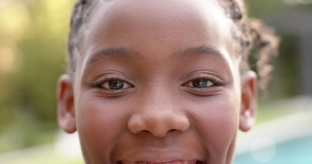 Close-up of African American girl smiling outdoors - Free Images, Stock Photos and Pictures on Pikwizard.com