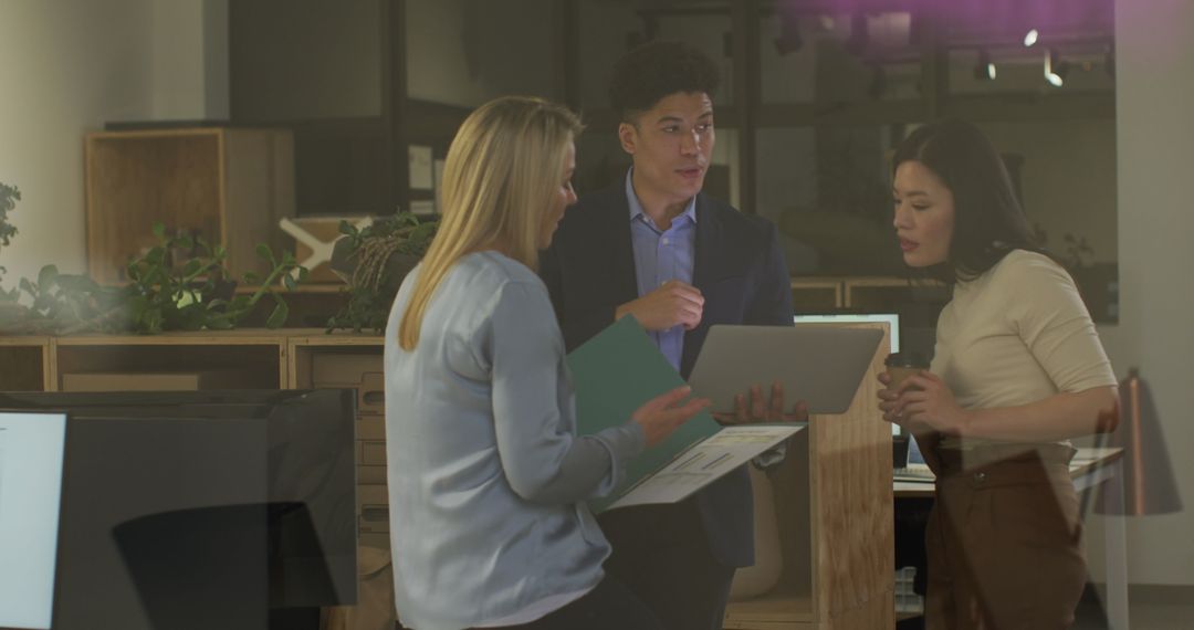 Diverse Team Engaged in Office Discussion in Modern Workplace