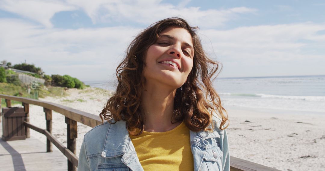 Happy Woman Enjoying Beach Day with Smile in Casual Denim Jacket - Free Images, Stock Photos and Pictures on Pikwizard.com