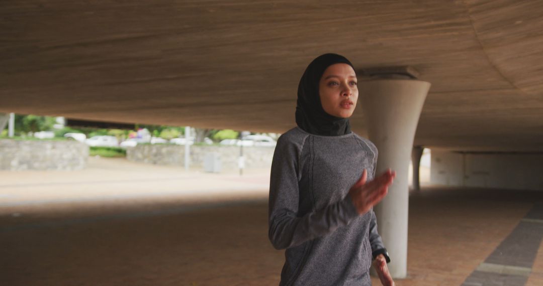 Young Muslim Woman Jogging Under Overpass for Fitness - Free Images, Stock Photos and Pictures on Pikwizard.com