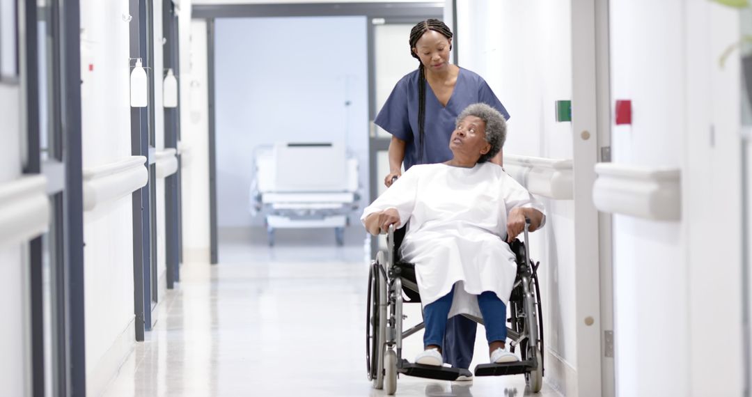 Nurse Assisting Senior Patient in Wheelchair at Hospital - Free Images, Stock Photos and Pictures on Pikwizard.com