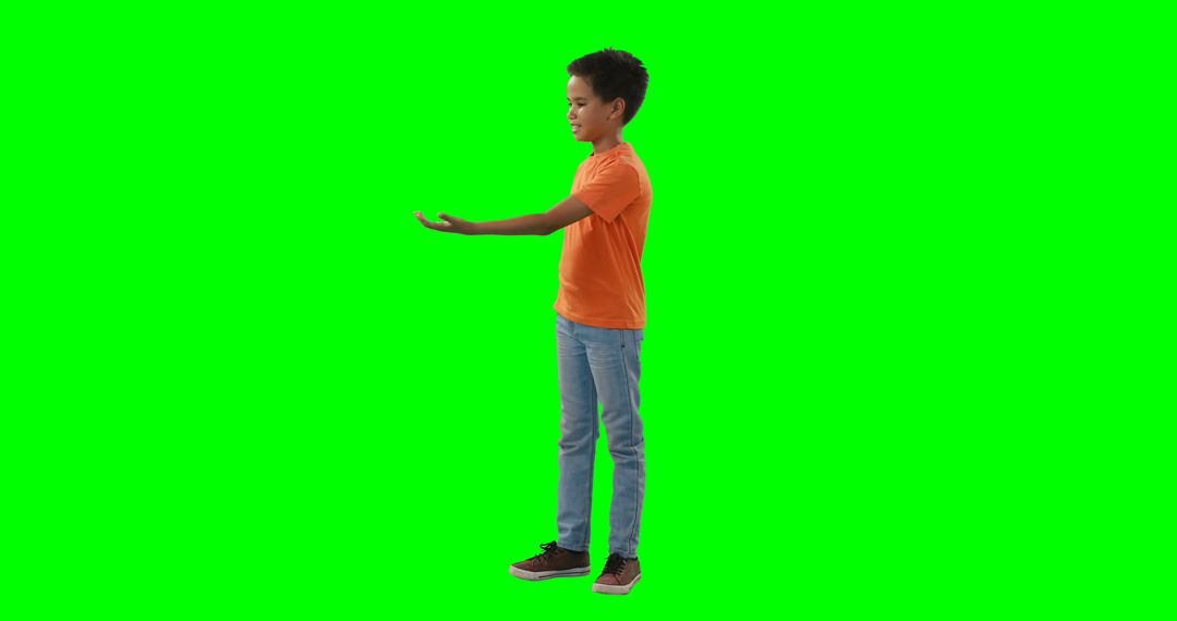 Boy with Outstretched Arm in Orange T-shirt Against Green Screen - Free Images, Stock Photos and Pictures on Pikwizard.com