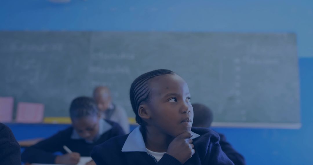 Thoughtful schoolgirl in uniform resting chin on hand, gazing during classroom lesson