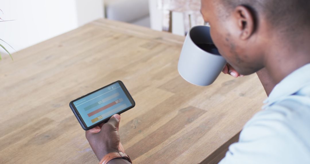 Man Monitoring Smart Home Energy Usage on Tablet