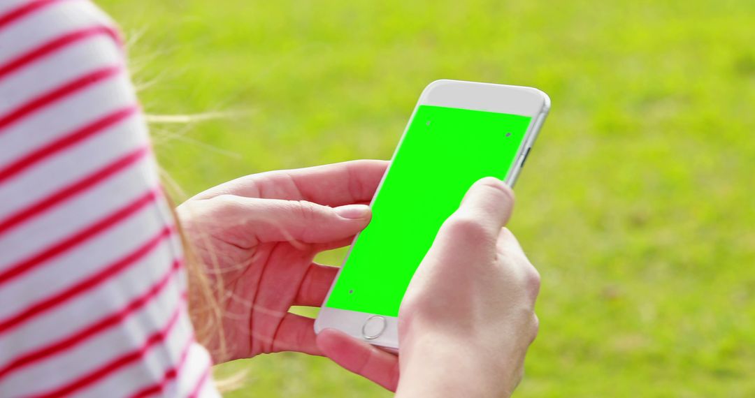 Woman Holding Smartphone with Green Screen Outdoors - Free Images, Stock Photos and Pictures on Pikwizard.com