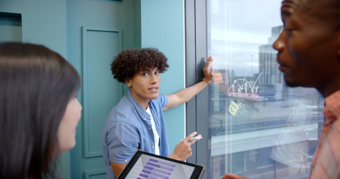 Diverse Team Brainstorming With Data by Office Window