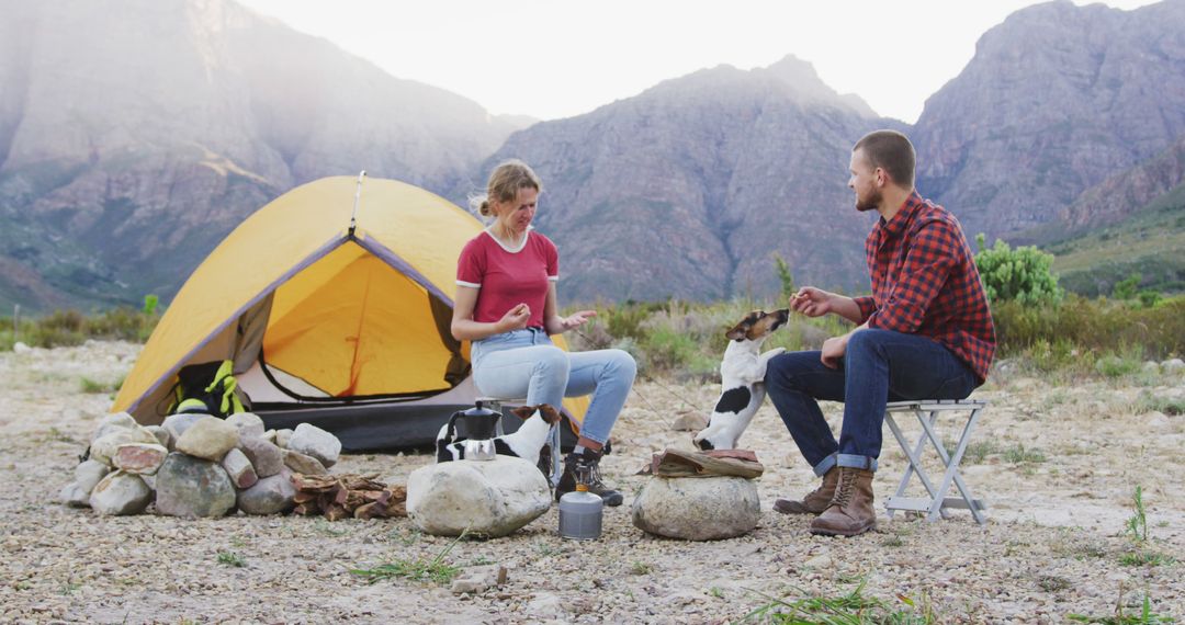 Couple Camping in Mountains with Dog in the Morning - Free Images, Stock Photos and Pictures on Pikwizard.com