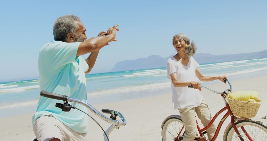 Senior Couple Enjoying Beach with Bicycles in the Sunshine