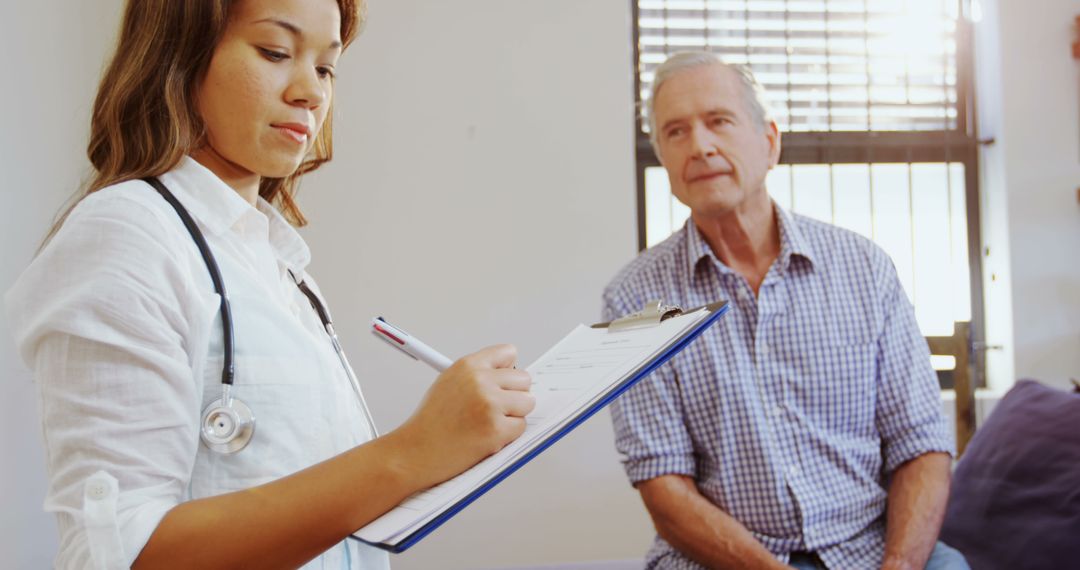 Doctor Taking Notes While Senior Patient Listens in Medical Office - Free Images, Stock Photos and Pictures on Pikwizard.com