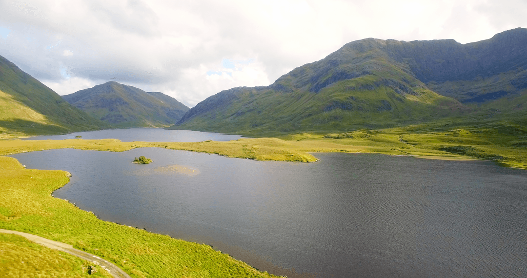 Transparent Lake with Lush Mountain Scenery at Sunrise