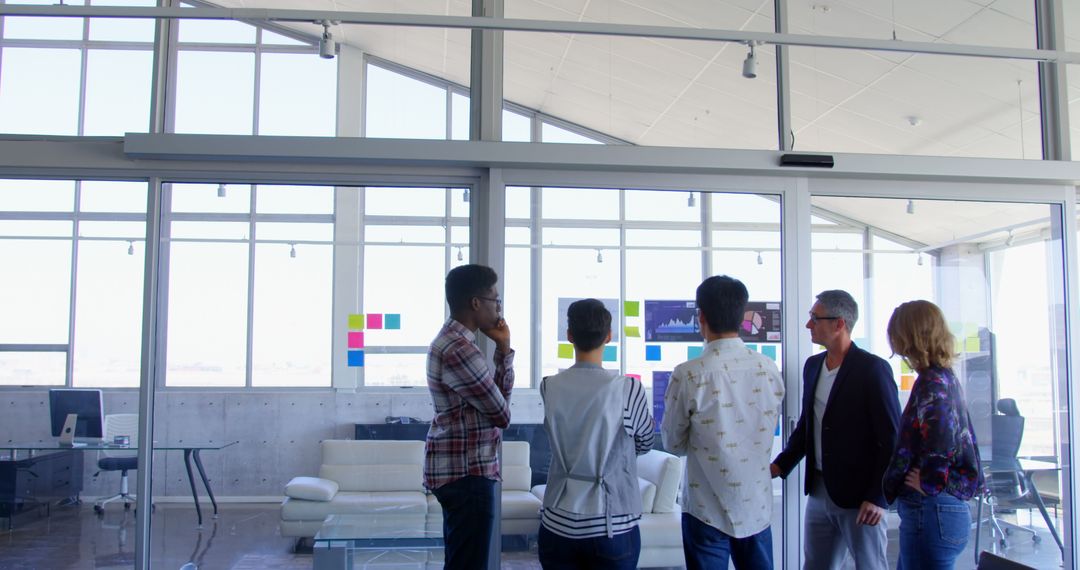 Diverse Team Analyzing Data in Contemporary Office Settings