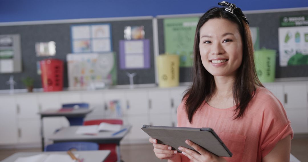 Smiling Teacher Using Tablet in Classroom - Free Images, Stock Photos and Pictures on Pikwizard.com