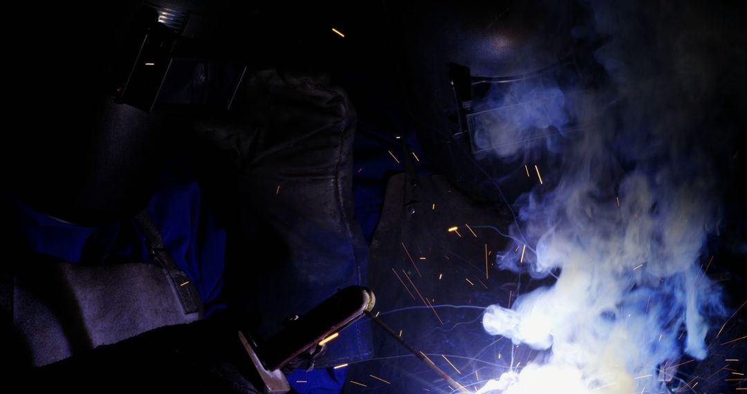 Welding Process with Sparks and Smoke in Dark Workshop - Free Images, Stock Photos and Pictures on Pikwizard.com