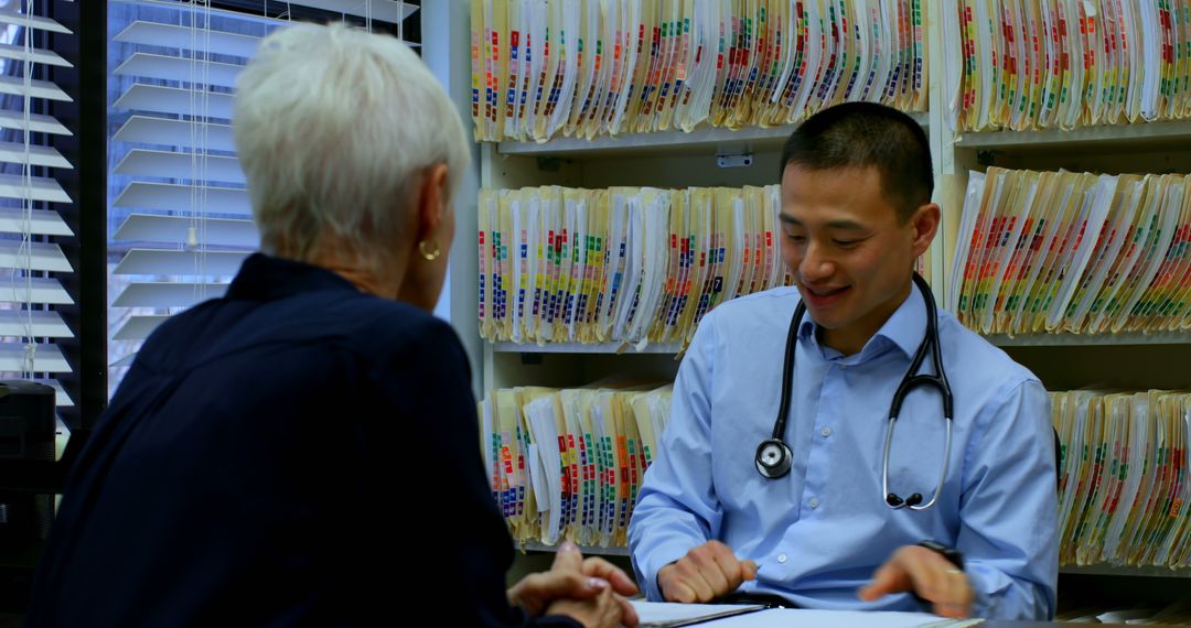 Doctor Consulting Patient in Office with Medical Records - Free Images, Stock Photos and Pictures on Pikwizard.com