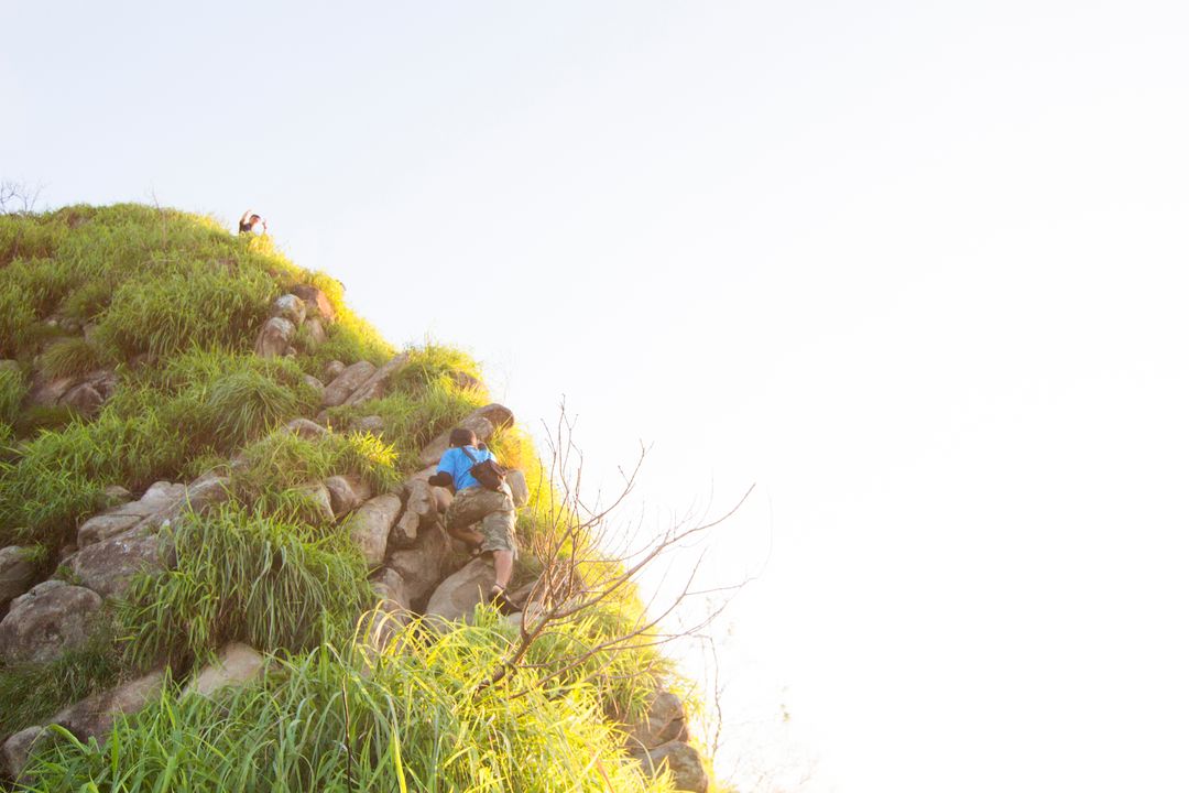 Children Climbing Rocky Hill on Bright Day - Free Images, Stock Photos and Pictures on Pikwizard.com