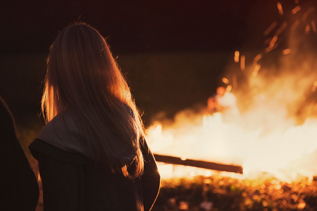 Woman Overlooking Evening Bonfire Outdoors - Free Images, Stock Photos and Pictures on Pikwizard.com