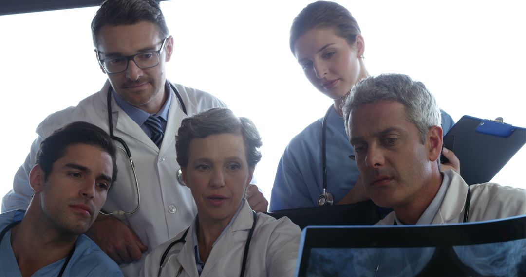 Medical Team Analyzing X-Rays Together in Hospital - Free Images, Stock Photos and Pictures on Pikwizard.com
