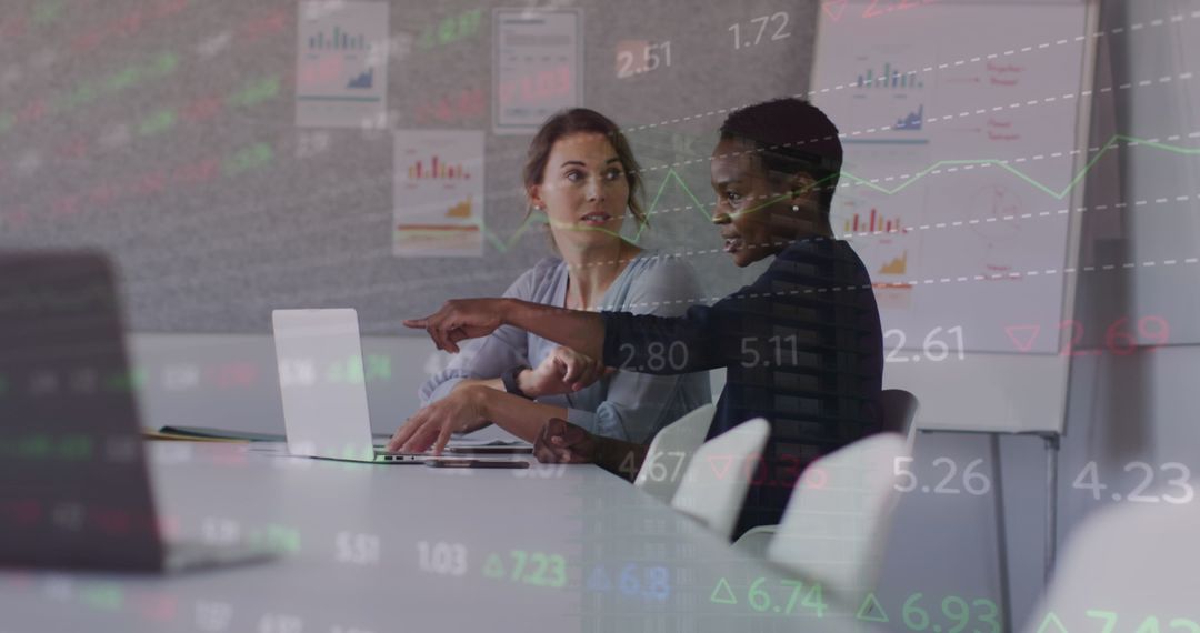 Female Coworkers Collaborating with Financial Analytics