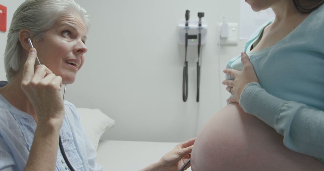 Doctor Using Stethoscope on Pregnant Woman's Belly in Clinic - Free Images, Stock Photos and Pictures on Pikwizard.com