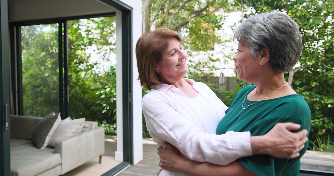 Joyful Connection: Mother and Daughter Hugging on Sunny Deck